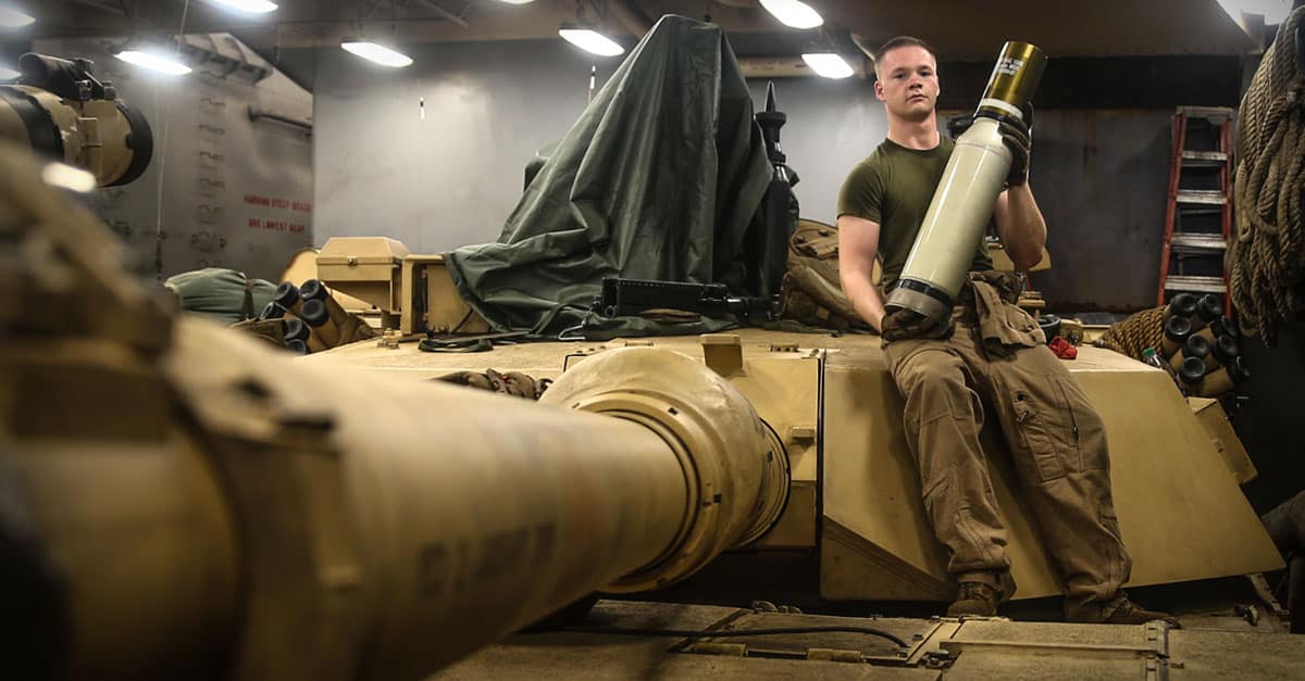 M1 Abrams- U.S. Marine Corps Cpl. Thomas Monahan holds an M1028 canister tank round aboard the Harpers Ferry-class dock landing ship