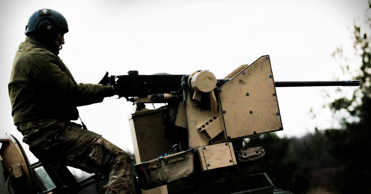 M1 Abrams- combat team fires a .50 caliber machine gun from the top of an M1A2 Abrams tank during training
