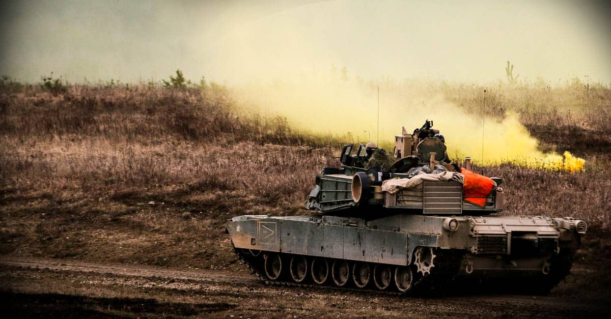 M1 Abrams - soldiers uses a smoke grenade to secure an area during a combined arms live fire exercise