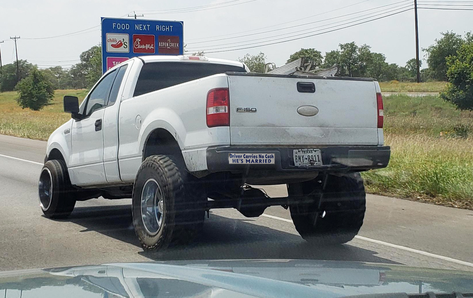 funny bumper stickers on white ford pick up truck