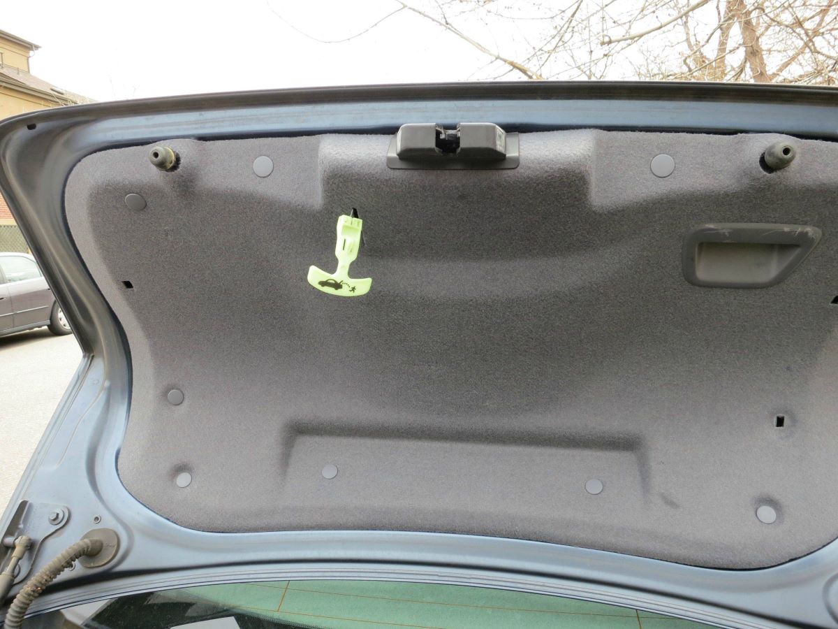 The T-shaped plastic handle is the trunk release